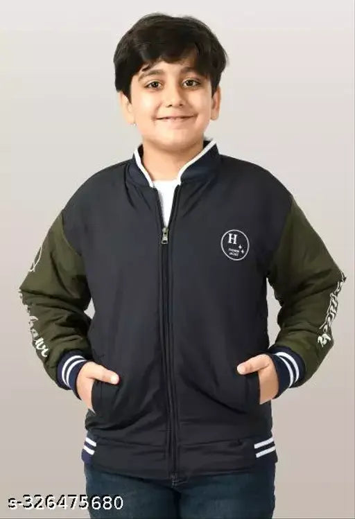 A young boy smiling at the camera, wearing a casual black jacket with white trim and brand logo