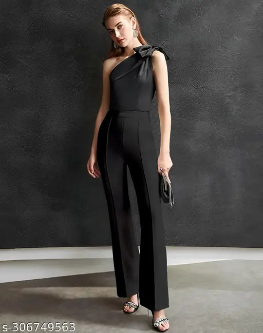 Black jumpsuit with high slits and black strappy heels