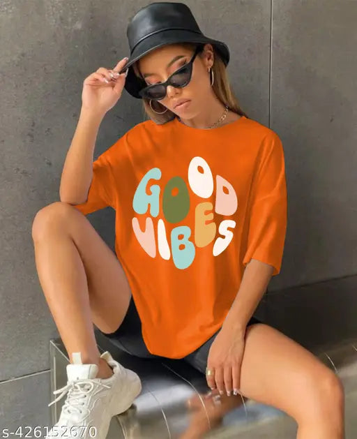 Orange t-shirt with 'GOOD VIBES' written in colorful letters