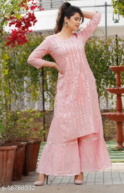 Pink rayon women's kurta and sharara set, featuring a round neckline and embroidered borders