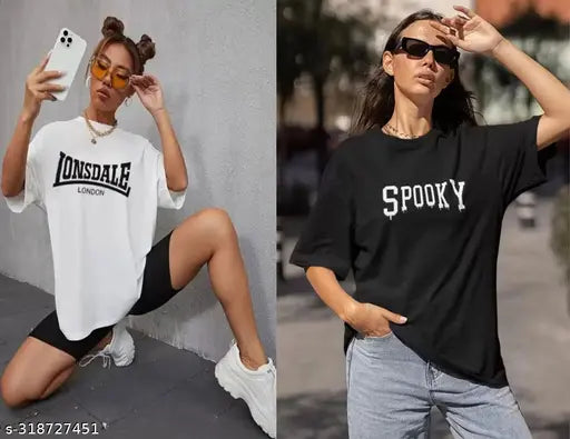 Two women in oversized T-shirts, one with a black shirt and Spooky design, posing against a city backdrop
