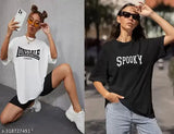 Two women in oversized T-shirts, one with a black shirt and Spooky design, posing against a city backdrop