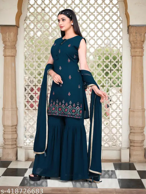 A woman in a dark blue georgette kameez and churidhar palazzo set with light makeup and hairstyle