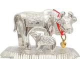Silver Kamdhenu cow statue with calf, Indian metal figurine for home office or car dashboard decor" (104 characters)