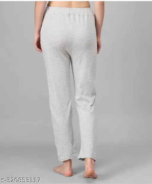 White printed pyjamas on a woman in front of a white background