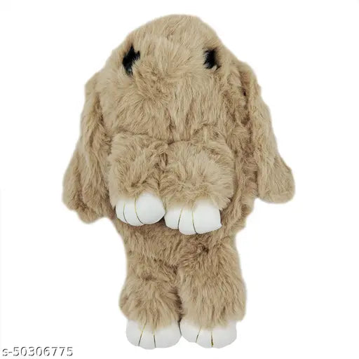 Fuzzy beige plush toy shaped like a rabbit with pink ears and black nose, carrying sling over shoulder