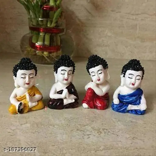 Multicolor polyresin baby monk Buddha statues (6x4x3 cm each), intricately designed by skilled Indian artists, ideal for home or office decor