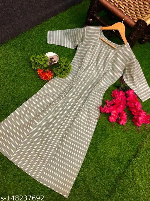 Premium cotton kurta on a mannequin, displayed on a green carpet with flowers