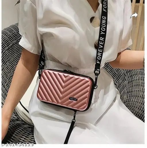 Hot pink sling bag with zipped closure, adjustable strap