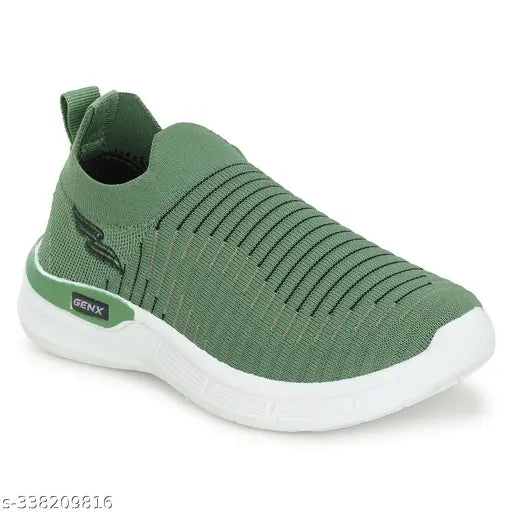 The image shows a pair of lightweight, memory foam kids' sports shoes with a stylish design. They are in a vibrant shade of green and appear to be made from a soft material. The shoes have a comfortable-looking fit and are designed for regular wear. They feature a white logo on the side and are suitable for casual or sporty use by children