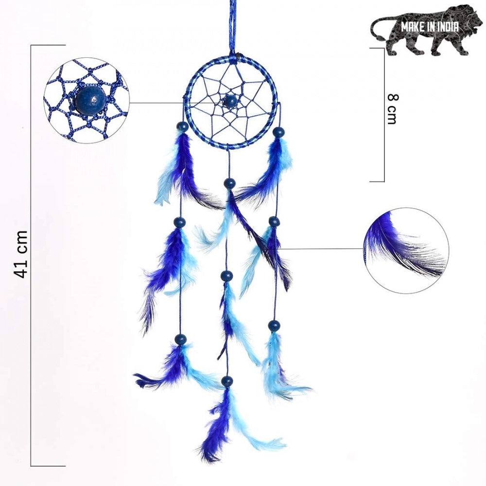 The image displays a dreamcatcher wall art piece. It features a starry night scene with feathers, beads, and intricate designs suspended from a hoop by strings. Made with natural materials and handcrafted details, it is designed for wall decoration