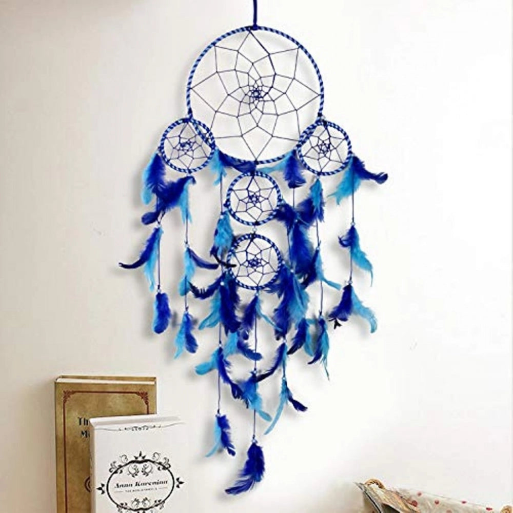 Handcrafted dream catcher wall art. Decorative tapestry with turquoise fringe, feather detailing, and attached to a white background