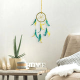 Yellow dream catcher with feather detail on white background
