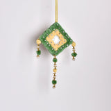 A decorative green and yellow pompom on a string, handmade wall art
