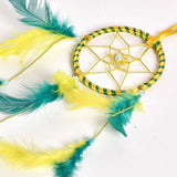 Handcrafted dreamcatcher wall art with beige base, turquoise feathers, gold ring