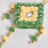 Yellow, green and blue handmade wall art with pompoms