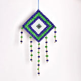 Multicolored handmade wall art with blue, green and white pompoms