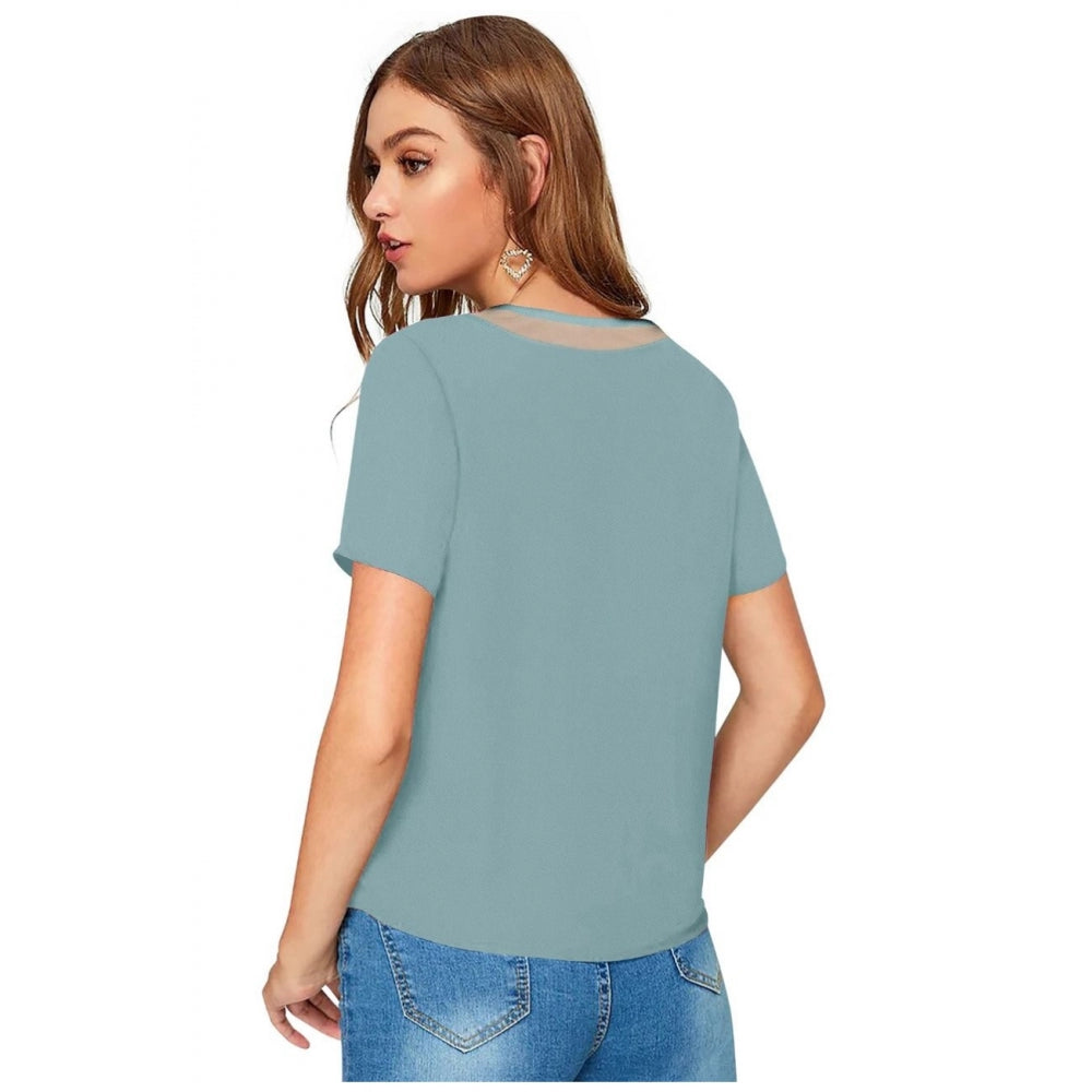 A woman wearing a blue Pista knitted Western style T-shirt with long sleeves