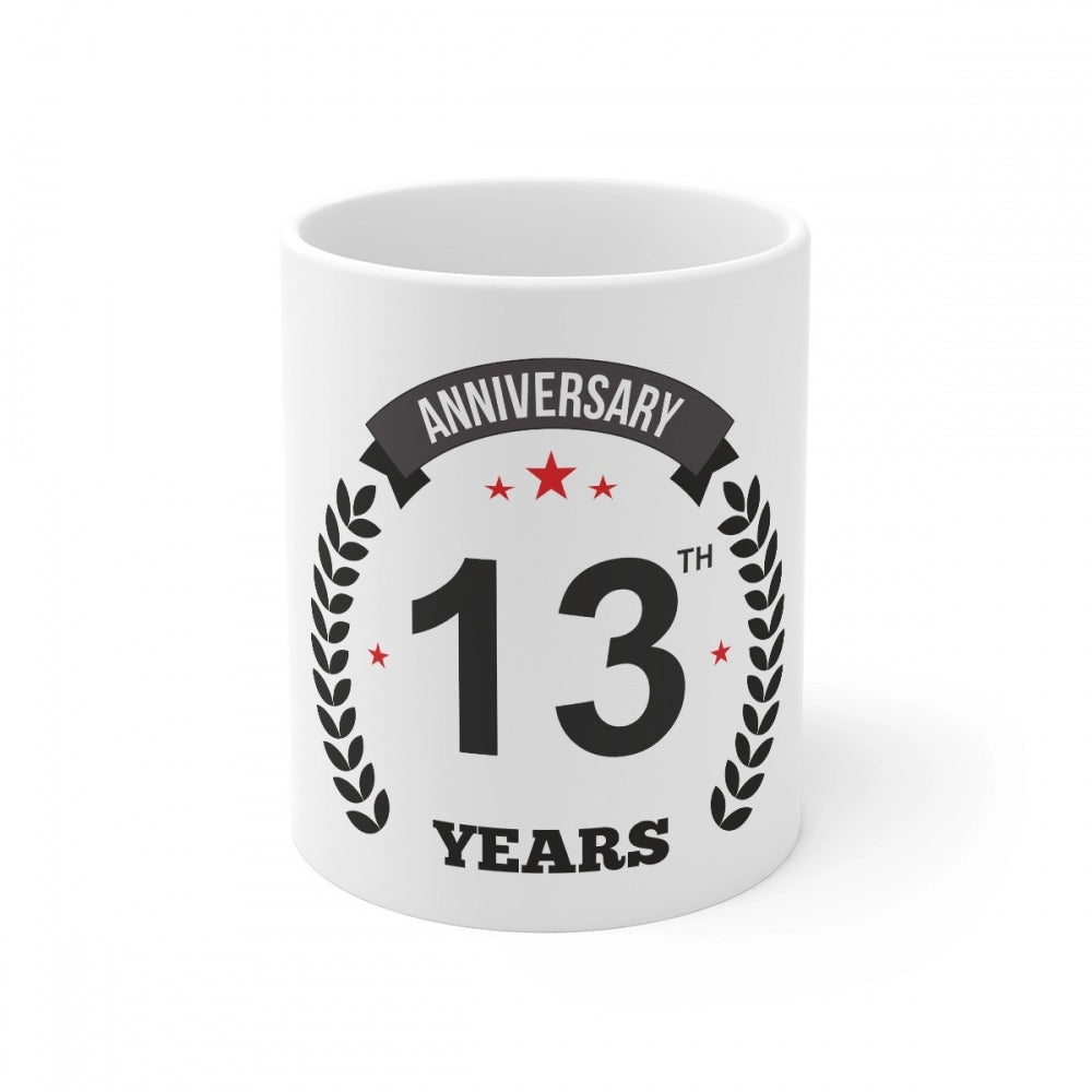 White ceramic coffee mug with printed anniversary message and star symbol