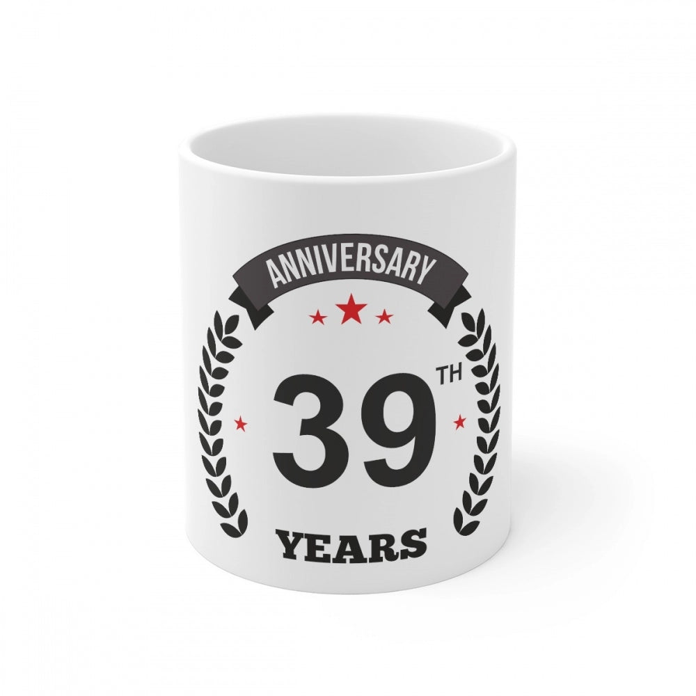 A white ceramic coffee mug with printed anniversary design and "39" years in black text