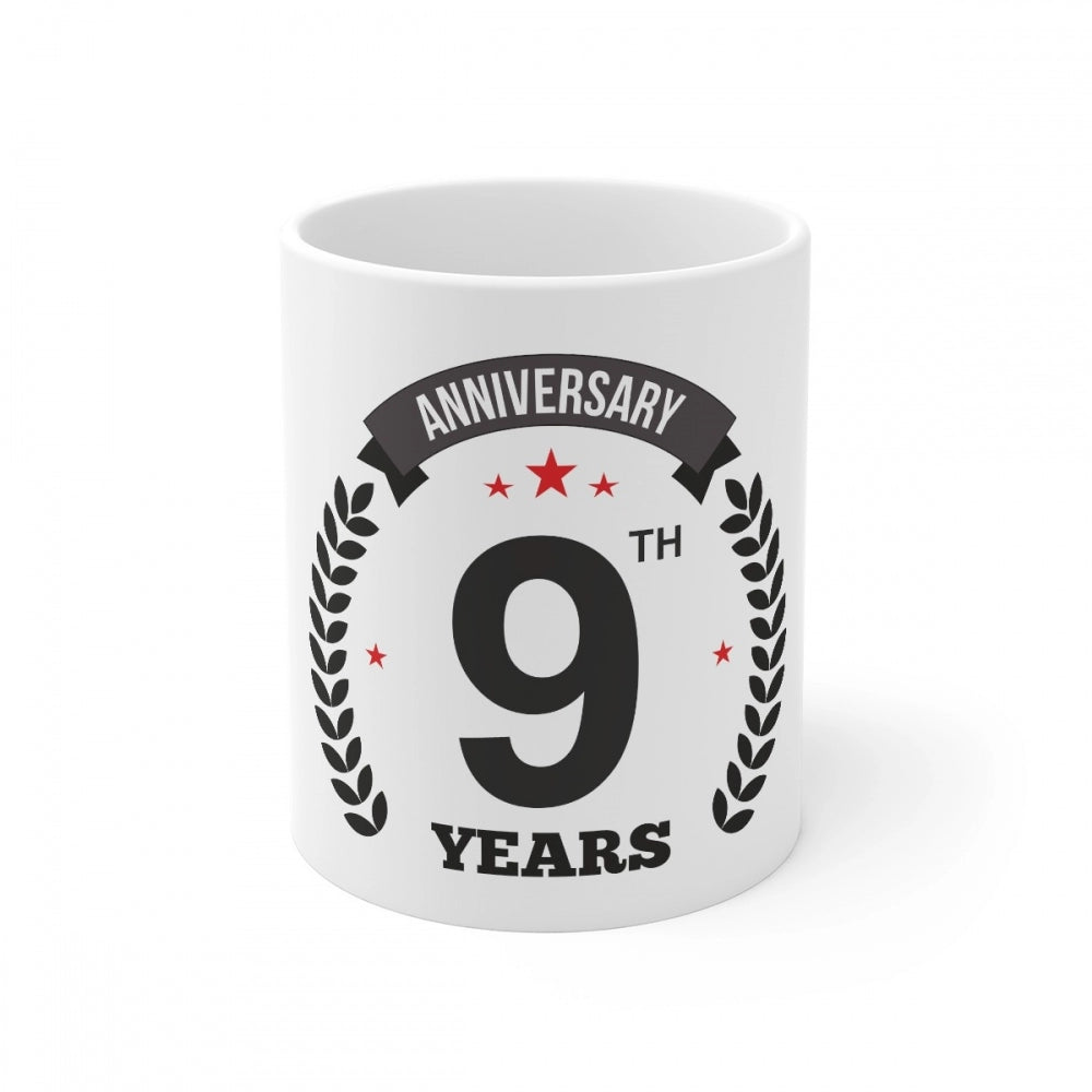 White ceramic coffee mug with anniversary print and capacity indicator
