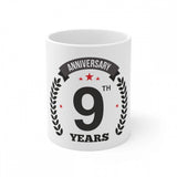 White ceramic coffee mug with anniversary print and capacity indicator