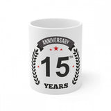 White ceramic coffee mug with black print celebrating 15 years
