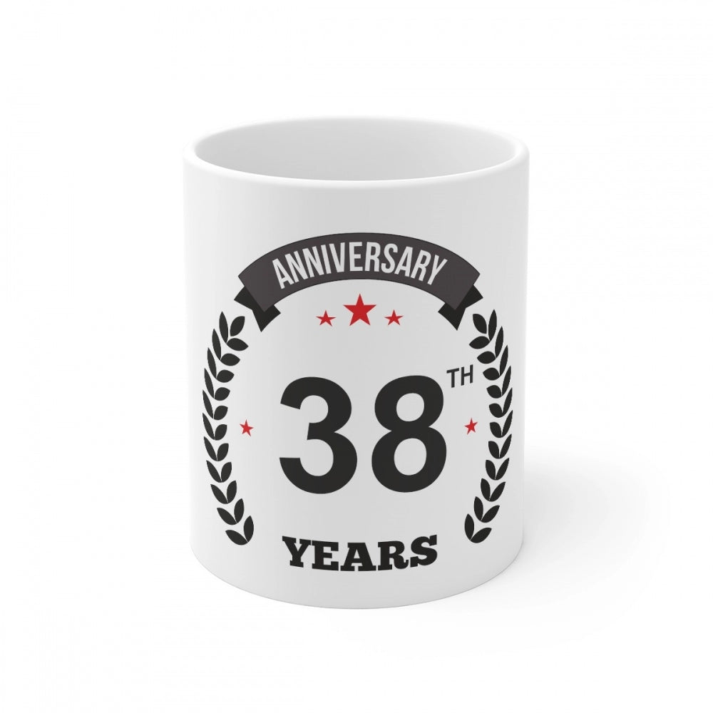 A white coffee mug with a black anniversary print
