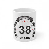 A white coffee mug with a black anniversary print