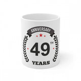 White ceramic coffee mug with printed anniversary message and number