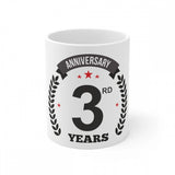 Ceramic coffee mug with white print reading 'Anniversary', and the number '3' in bold. The mug is colored white and has a 330ml capacity