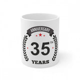 White ceramic coffee mug commemorating 35th anniversary with printed design and "anniversary print", 330ml