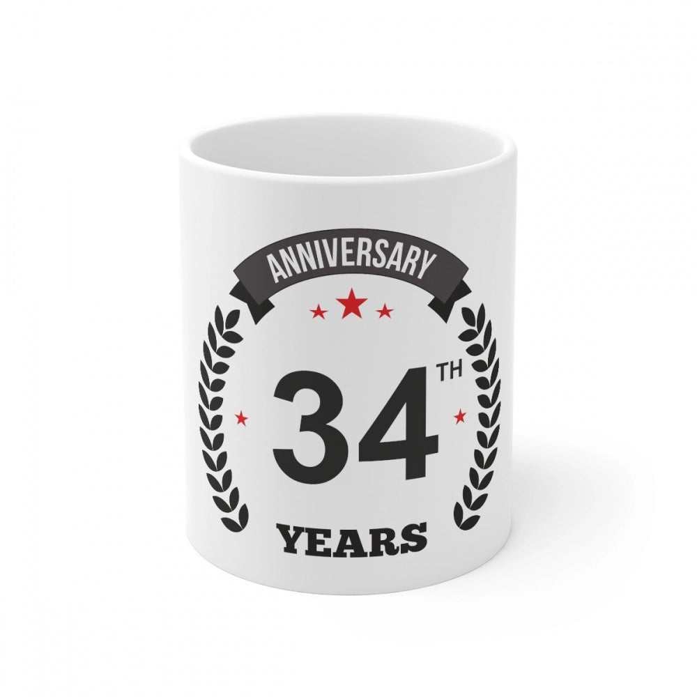 White ceramic coffee mug with "Anniversary" and "34 Years" printed text and 330ml capacity