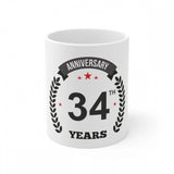 White ceramic coffee mug with "Anniversary" and "34 Years" printed text and 330ml capacity