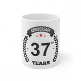 White ceramic coffee mug with anniversary print and laurel design