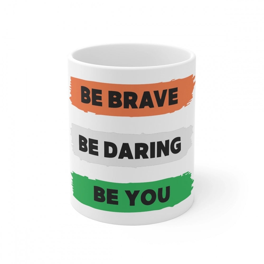 White ceramic mug with 'Be Brave Be Daring Be You' printed in multi-colored text and a rainbow stripe design