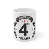White ceramic mug with black anniversary print, white background