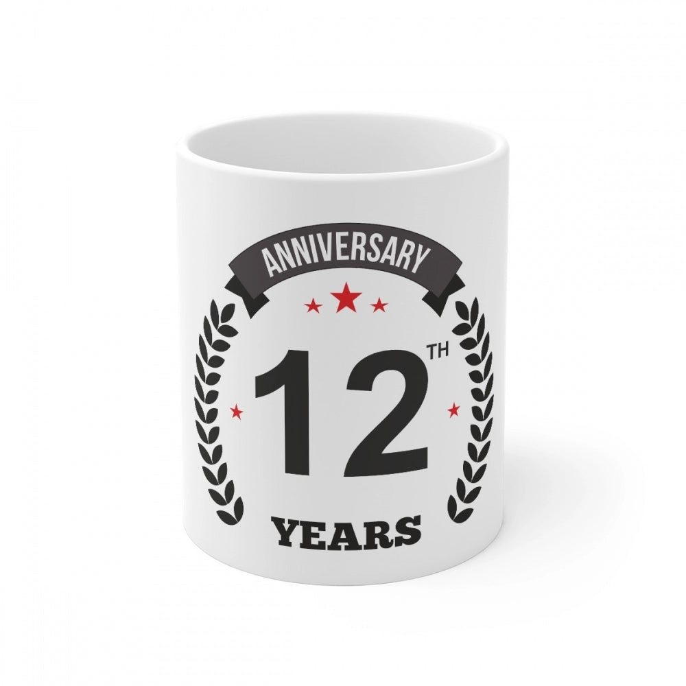 White ceramic coffee mug with a printed anniversary design and '12th' indicating it's for a 12th anniversary celebration