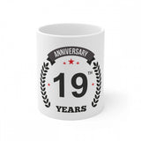 White ceramic mug with anniversary print and laurel wreath