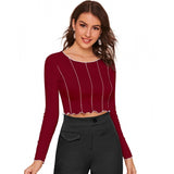 Maroon cropped top with ruffled neckline and frayed hem, worn by model