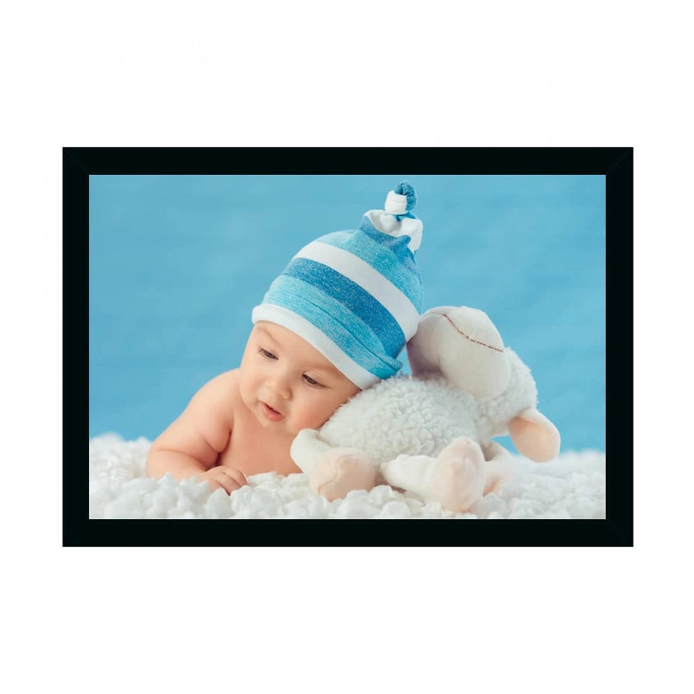 Multicolored photo frame painting of baby in swaddle, sitting on white cushion