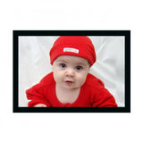 A framed photo of a baby painted in various colors