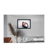A baby painting in a synthetic frame, mounted on a wall
