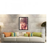A wall painting of a baby's photo inside a colorful, synthetic frame
