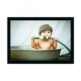 Multicolored photo frame with baby in white tub, painted background