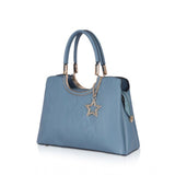 Long, blue, faux leather handbag with adjustable strap and printed design