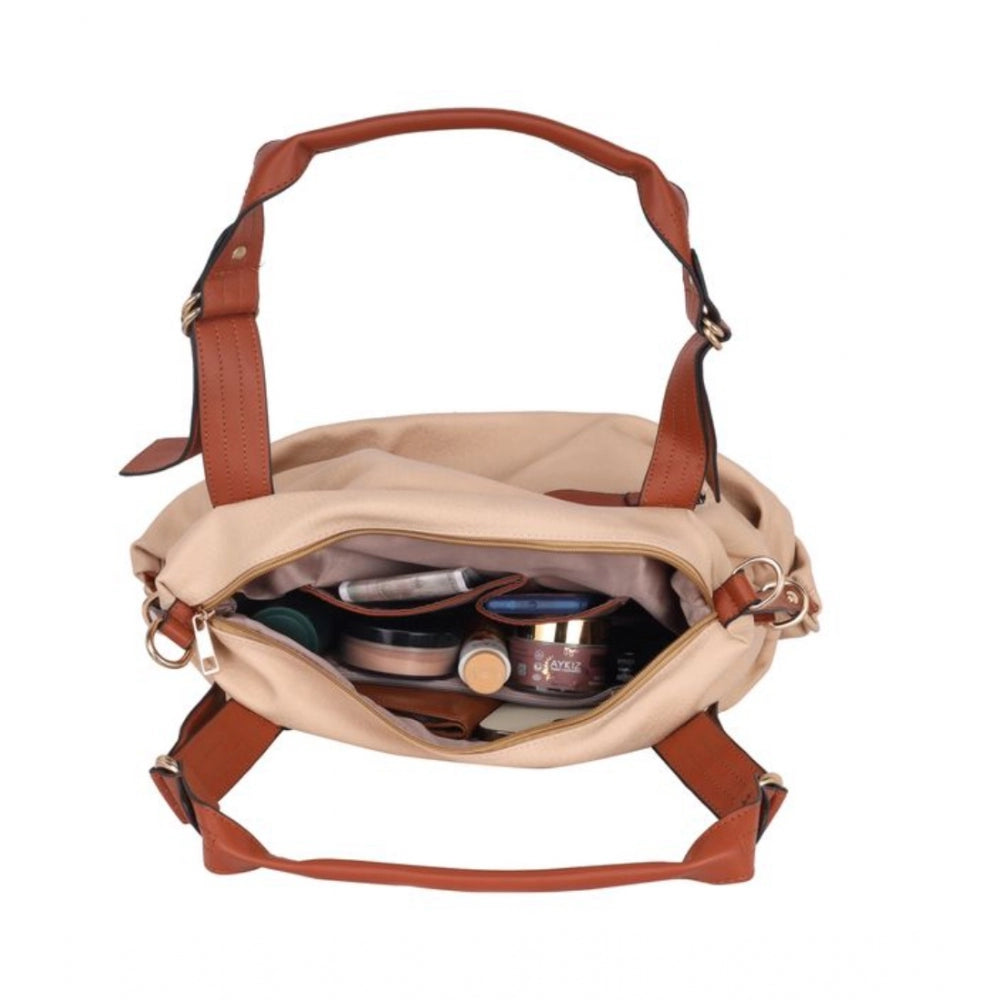 A beige faux leather solid tote bag with a shoulder strap and multiple compartments, featuring zip closures and an open top
