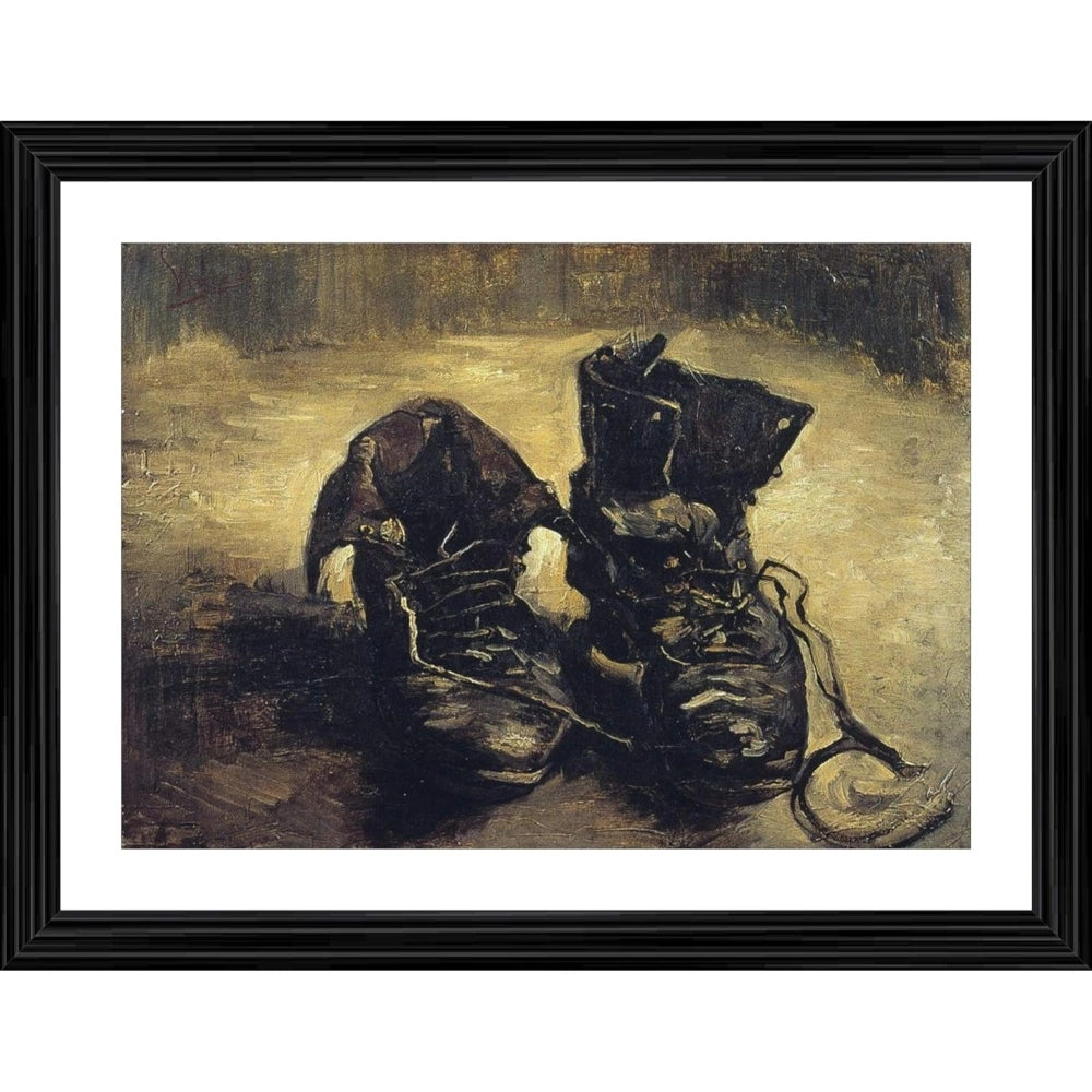 Black boots, worn and torn, displayed in a wood photo frame