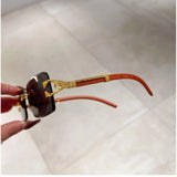Black metal retro square sunglasses with UV400 protection for unisex, classic design on display