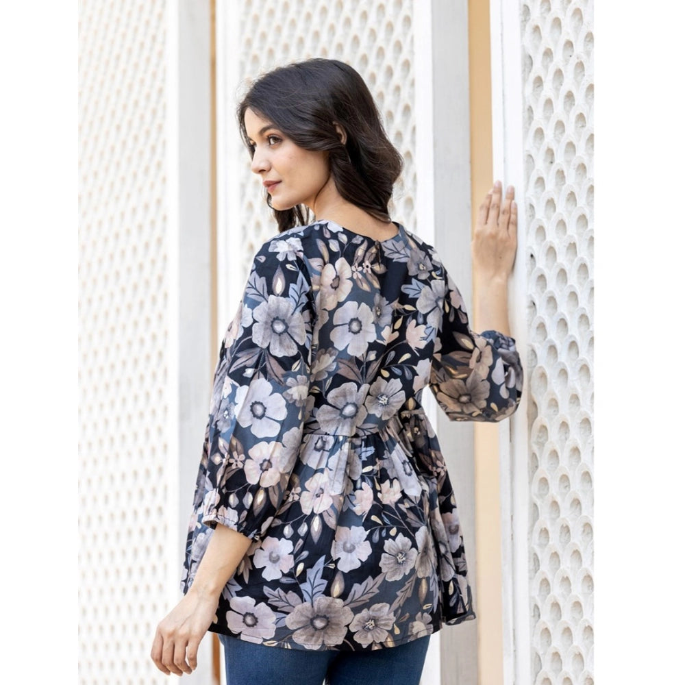 Black cotton printed 3/4 sleeve v-neck top with vivid pattern detail on a clothing rack